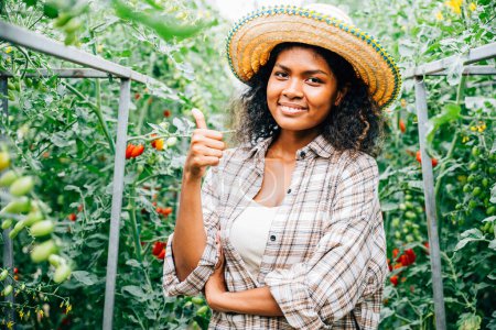 Photo for In a hydroponic greenhouse female farmers check tomato quality smiling and giving thumbs up. Their portraits depict dedication to good growth successful entrepreneurship and joyful outdoor farming. - Royalty Free Image