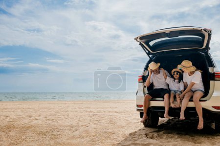Photo for People enjoying road trip sitting down on back their car, Parents and children traveling in holiday at sea beach, family fun in summer vacation on beach blue sky, Happy Family and World Tourism Day - Royalty Free Image