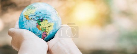 Photo for In honor of World Earth Day, embrace a green leaf and the globe, symbolizing Green Energy, ESG, and Environmental Care. Take on global responsibility for a sustainable and clean environment. - Royalty Free Image