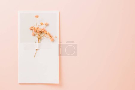 Photo for Beautiful spring flowers on paper card pastel pink background, Small wedding flower from above, Mothers Day, Valentines Day, summer concept - Royalty Free Image
