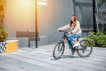 Photo for Happy Asian young woman riding bicycle on street outdoor near building city, Portrait of smiling female lifestyle use mountain bike in summer travel means of transportation, ECO friendly, Urban biking - Royalty Free Image