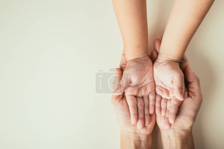 Photo for Top view of parents and kid holding empty hands on color background. Celebrating Family Day illustrating togetherness support and legacy. - Royalty Free Image