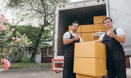Photo for Employee team unloads boxes from truck showcasing excellent service for customer relocation. Smiling faces ensure a smooth move to their new home. Moving Day - Royalty Free Image
