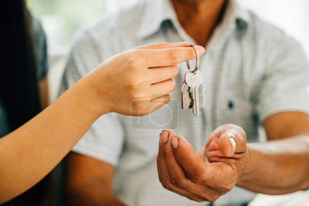 Photo for A cheerful couple displays keys to their new house symbolizing happiness and success in their real estate purchase. Reflecting joy achievement and excitement in homeownership. - Royalty Free Image
