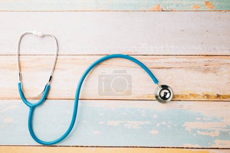 Photo for Top view blue medical stethoscope on wooden background with copy space for you text, Doctor equipment, healthcare and medical, Doctor Day and World cancer day Concept - Royalty Free Image