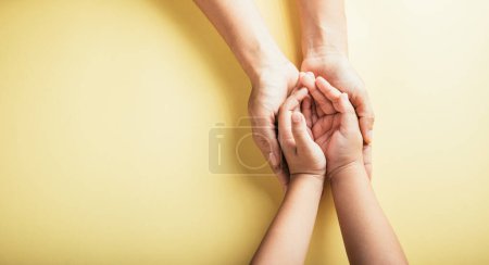 Photo for Studio shot, Close-up top view of family hands stacked isolated background. Parents and child hold empty space together signifying support and love on Family and Parents Day. - Royalty Free Image