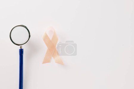 Foto de Pink awareness ribbon sign and stethoscope of International World Cancer Day campaign month isolated on white background with copy space, concept of medical and health care support, 4 February - Imagen libre de derechos