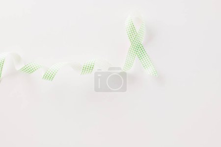 Photo for Green awareness ribbon of Gallbladder and Bile Duct Cancer month isolated on white background with copy space, concept of medical and health care support, Cancer awareness, World kidney day - Royalty Free Image