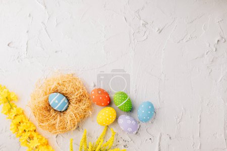 Foto de Top view holiday banner background web design white easter eggs in brown nest on white cement background with empty copy space, celebration greeting card, overhead, template, Happy Easter Day Concept - Imagen libre de derechos