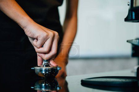 Professional coffee machine prepares fresh tasty coffee in cafe. Step by step tips for making perfect brew. Close up of machine hand holding handle pouring delicious drink.