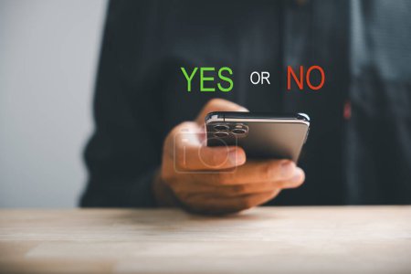 Photo for With smartphones businessman presents right and wrong icons for yes or no decision-making. Communication of choice and expertise. Think With Yes Or No Choice. - Royalty Free Image