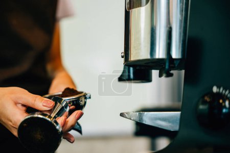 Photo for Coffee machine prepares tasty coffee at cafe. Step by step brewing tips showcased. Close up of machine hand holding handle demonstrating professional coffee making at restaurant. - Royalty Free Image