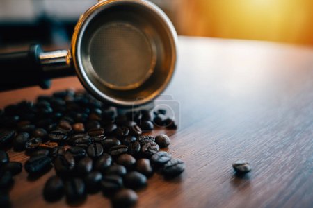 Photo for Coffee beans and tamper on a modern table. Metal equipment for espresso preparation. Organic beans restaurant setting with mocha cup gourmet refreshment. - Royalty Free Image