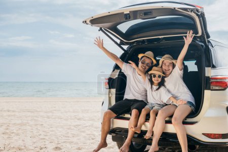 Photo for Family Day. Father, Mother and daughter enjoying road trip sitting on family back car raise hand up, Happy people having fun in summer vacation on beach, Family traveling in holiday at sea beach - Royalty Free Image