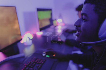Photo for Young gamers having fun playing online video games with computer at home - Gaming entertainment and technology concept - Royalty Free Image