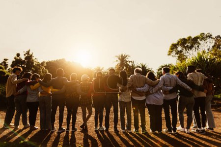 Photo for Back view of happy multigenerational people having fun in a public park during sunset time - Community and support concept - Royalty Free Image