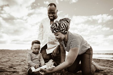Photo for Happy African family having fun on the beach during summer vacations - Black and white editing - Royalty Free Image