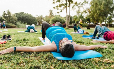 Photo for Close up senior woman doing workout activity with a group of friends in a public park - Health elderly people lifestyle - Royalty Free Image