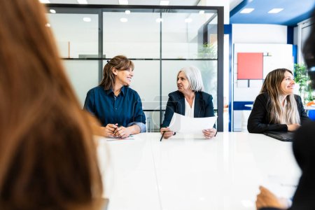 Photo for Business women doing a briefing in boardroom of modern office - Brainstorming and teamwork concept - Royalty Free Image