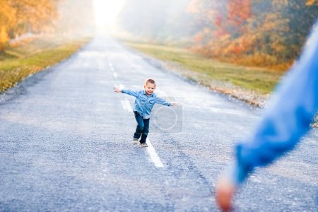 Photo for Happy parent with child are walking along the road in the park on nature travel - Royalty Free Image