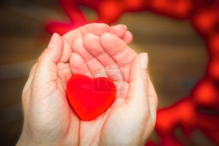 Photo for Heart in hands on valentine's day on a wooden background holiday - Royalty Free Image