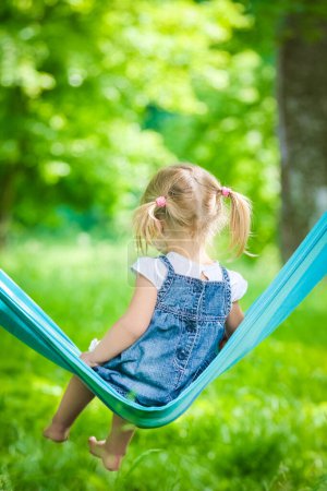 Photo for Happy baby in a hammock outdoors in the park - Royalty Free Image