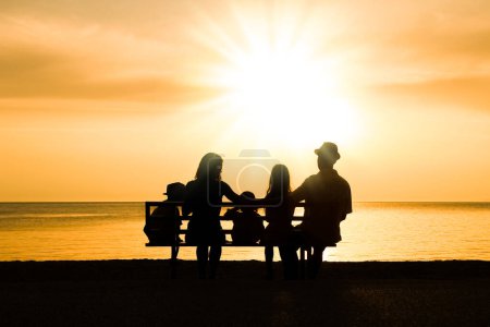 Photo for Happy family in nature by the sea on a trip silhouette - Royalty Free Image