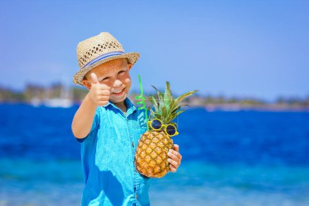 Photo for Pineapple in the hands of a man by the sea in nature on a journey background - Royalty Free Image
