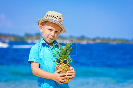 Photo for Pineapple in the hands of a man by the sea in nature on a journey background - Royalty Free Image