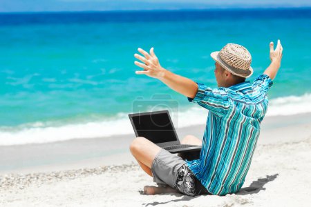 Photo for Happy man guy with laptop near the seashore weekend travel - Royalty Free Image