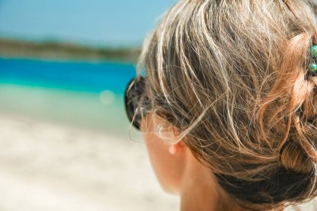 Téléchargez les photos : Fille heureuse avec des lunettes de soleil au bord de la mer sur fond de nature - en image libre de droit