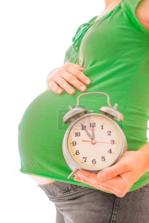 Photo for Beautiful young pregnant girl on a white background with alarm clock - Royalty Free Image