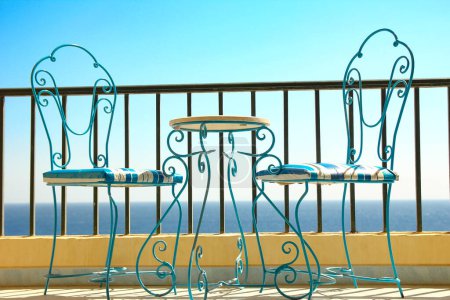 Photo for Beautifully stylish table chairs on the sea shore background - Royalty Free Image