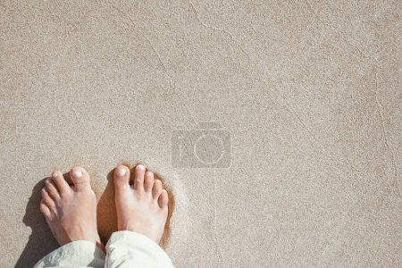 Photo for Beautiful traces with feet on sea nature background - Royalty Free Image
