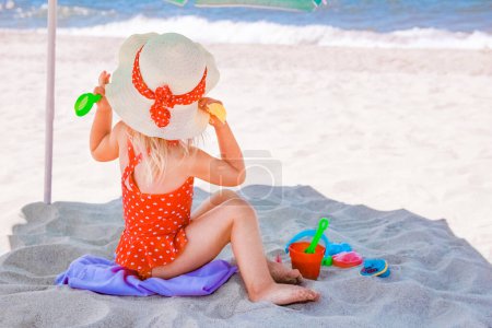 Photo for Happy baby girl on the sea in the summer on the nature - Royalty Free Image
