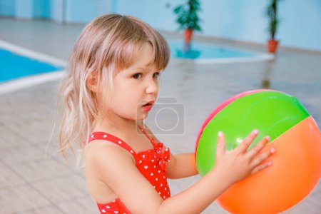 Photo for Happy child on the beach near the swimming pool outdoors in summer park - Royalty Free Image