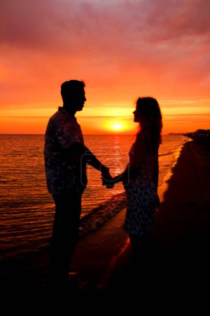 Photo for Silhouette of a happy couple at sunrise on summer nature - Royalty Free Image