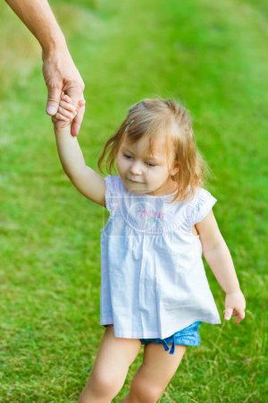 Photo for Beautiful hands of parent and child outdoors in the park - Royalty Free Image