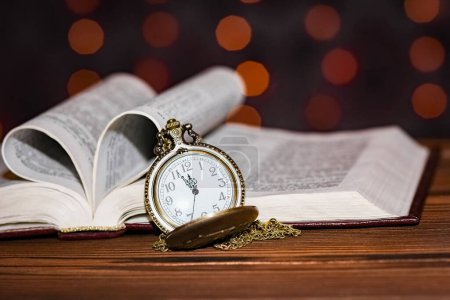 Photo for Pocket watch with book background - Royalty Free Image
