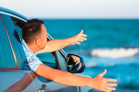 Photo for Happy guy in the car by the sea in nature on vacation travel - Royalty Free Image
