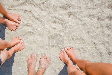 Photo for Feet on the sand of happy people by the sea on nature travel - Royalty Free Image