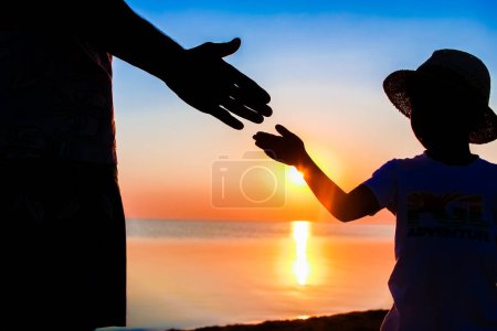 Photo for Hands of happy father and child by the sea on nature silhouette travel - Royalty Free Image