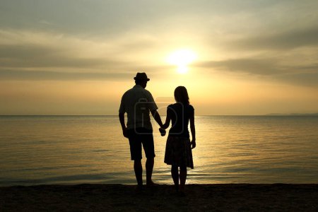 Photo for Happy couple by the sea on nature in travel silhouette - Royalty Free Image