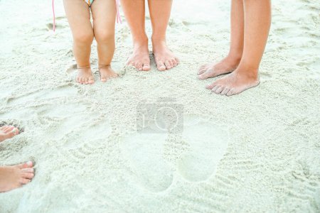 Photo for Beautiful legs on the sand by the sea - Royalty Free Image