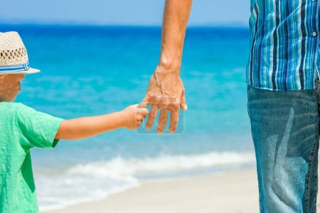 Téléchargez les photos : Hands of a happy parent and child on the seashore on a journey trip in nature - en image libre de droit