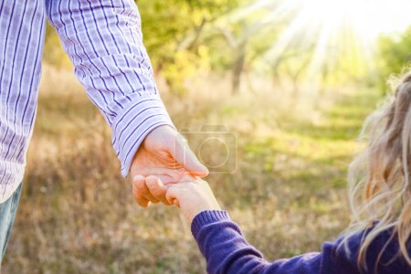 Photo for The parent holding the child's hand with a happy background - Royalty Free Image