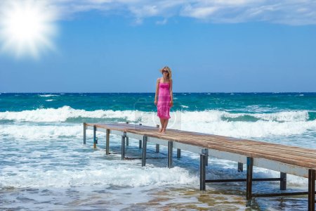 Photo for Beautiful girl on the pier of the sea shore - Royalty Free Image