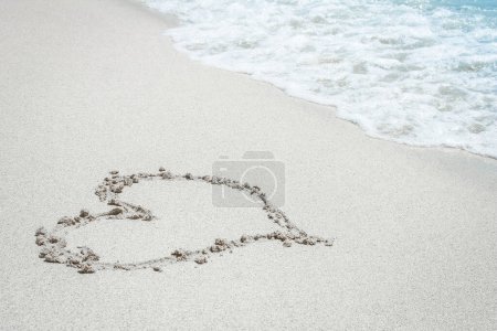Photo for Beautiful drawing on the sand near the sea shore background - Royalty Free Image