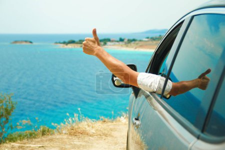 Photo for Happy guy in auto sea background - Royalty Free Image