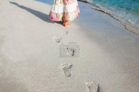 Photo for Beautiful footprints with feet on the sand background - Royalty Free Image